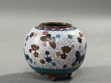 a vase with a flower design on it on a table