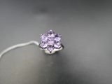a close up of a ring on a table with a tag