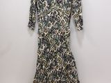 a woman ' s dress on a hanger against a wall