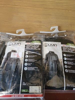 three bags of clothing sitting on a shelf in a store