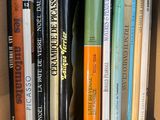 many books that are in a box on the shelf