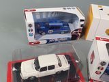 two toy cars that are in a box on a table