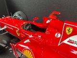 the red ferrari racing car is on display in a display case