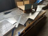 a pile of metal sheets sitting on top of a pallet