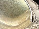 a silver spoon and a silver spoon sitting on a table