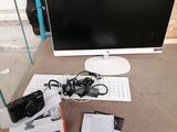 an image of a desk with a computer monitor, keyboard, mouse, and other items