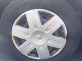a tire that is sitting on the ground next to a car