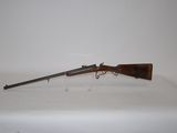 an old gun on a white surface with a white background