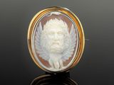 an antique carved shell cameo of a man with wings