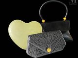 a black purse and a yellow purse on a black background