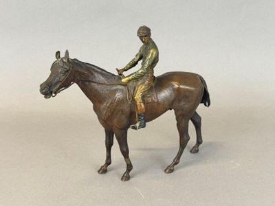 a bronze statue of a jockey on a horse
