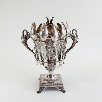 a silver bowl with spoons and spoons in it