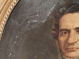 portrait of a man in a suit and bow tie in a gold frame