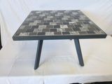a black and white tiled table on a white table cloth