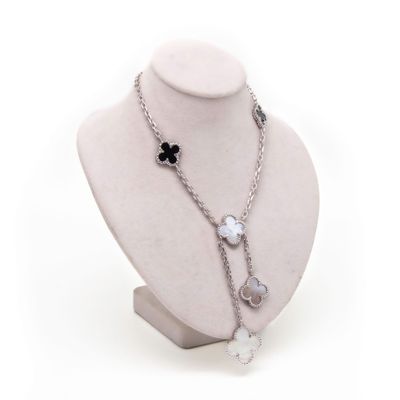 a mannequin with a necklace and a flower on it