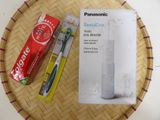 two toothbrushes and a tube of toothpaste on a tray