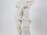 statue of a woman holding a basket of flowers on a pedestal