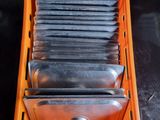 a bunch of knives in a plastic container