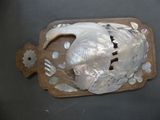 a fish shaped object on a cutting board on a table
