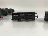 three toy trains are lined up on a white surface