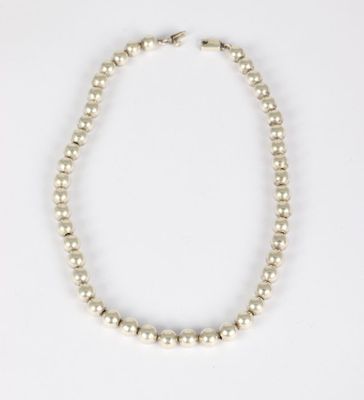 a white pearl necklace on a white background