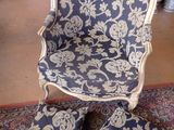 a blue and white chair and ottoman in a room
