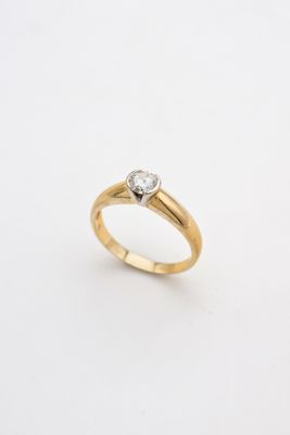 a yellow gold ring with a single diamond on top
