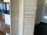 a room with a shelf and a bookcase in it