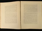 an open book on a black table with a black background