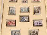 an old picture of a collection of stamps on display on a table