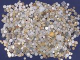 a pile of coins on a blue surface