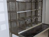 a metal table with a shelf on it in a room
