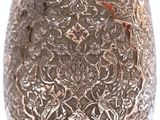 a silver vase that is sitting on a table