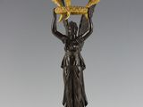 pair of antique bronze candlesticks with a woman holding two candles