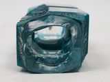 a close up of a blue glass object on a table