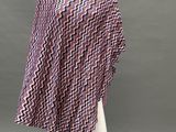 a mannequin mannequin wearing a purple and black zigzag ponch