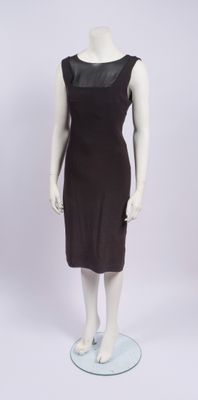 the mannequin is wearing a brown dress with a black top