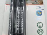 three black marker pens are in a package on a white surface