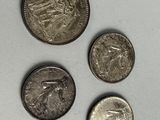 three different types of coins are shown on a white surface