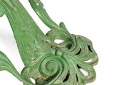a close up of a green metal object on a white surface