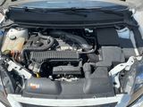 the engine of a car with its hood open and the hood down