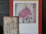 a picture of a painting and a picture of a fish on a shelf