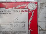 a red and white poster on the wall of a building
