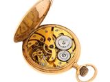 an image of a gold pocket watch with gears and a key