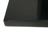 a black box with a black lid on a white surface