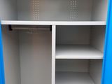 a blue and white closet with shelves in it