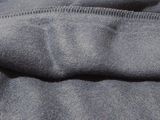 a close up of a black jacket with a white logo on it