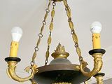 a chandelier with three lights hanging from the ceiling