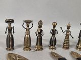 seven figurines of different sizes and shapes on a table