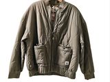 an image of a jacket hanging on a hanger on a white wall